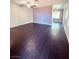 Spacious living room featuring dark wood-look floors and ceiling fan at 7123 Kenwood St, Las Vegas, NV 89147