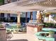 Outdoor BBQ area with grill, picnic tables, and green landscaping at 7135 S Durango Dr # 314, Las Vegas, NV 89113
