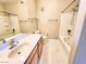 Well-lit bathroom featuring double vanity, tile floors, and a shower-tub combination at 7135 S Durango Dr # 314, Las Vegas, NV 89113