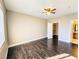 Bedroom features hardwood floors, a ceiling fan, and an open closet with easy access at 7135 S Durango Dr # 314, Las Vegas, NV 89113