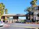 Community gated entrance with a white car in the foreground and buildings in the background at 7135 S Durango Dr # 314, Las Vegas, NV 89113