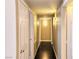Hallway with multiple doors leading to different rooms and dark hardwood flooring at 7135 S Durango Dr # 314, Las Vegas, NV 89113