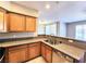 Updated kitchen with granite countertops, stainless steel sink, and natural wood cabinets at 7135 S Durango Dr # 314, Las Vegas, NV 89113