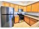 Bright kitchen with stainless steel appliances and wood cabinets, offering a modern cooking space at 7135 S Durango Dr # 314, Las Vegas, NV 89113