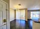 Inviting living space showcasing hardwood floors, chandelier, and sliding glass doors to balcony, blending style and functionality at 7135 S Durango Dr # 314, Las Vegas, NV 89113