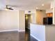 Spacious living area with a ceiling fan, modern lighting, and a breakfast bar connecting to the kitchen, ideal for entertaining at 7135 S Durango Dr # 314, Las Vegas, NV 89113