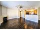 Open-concept living area featuring a fireplace, breakfast bar, and hardwood floors, creating a warm and inviting atmosphere at 7135 S Durango Dr # 314, Las Vegas, NV 89113