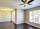 Inviting living room space features hardwood floors, chandelier, and a large window with blinds at 7135 S Durango Dr # 314, Las Vegas, NV 89113
