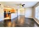 Spacious living room featuring hardwood floors, ceiling fan, and connecting open-plan kitchen at 7135 S Durango Dr # 314, Las Vegas, NV 89113