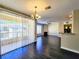 Bright open-concept living area with a fireplace, balcony access, and sleek dark hardwood floors, perfect for modern living at 7135 S Durango Dr # 314, Las Vegas, NV 89113