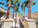 Scenic walkway lined with lush palm trees, providing a tranquil path through the well-maintained community at 7135 S Durango Dr # 314, Las Vegas, NV 89113
