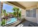 Balcony overlooking a community pool and palm trees, with a small window on the right at 7173 S Durango Dr # 307, Las Vegas, NV 89113