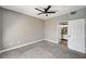 Neutral bedroom with ceiling fan and doorway to the en suite bathroom at 7173 S Durango Dr # 307, Las Vegas, NV 89113