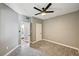 Bedroom with ceiling fan, a doorway to a closet and bathroom, and carpet flooring at 7173 S Durango Dr # 307, Las Vegas, NV 89113