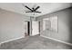 Neutral bedroom with ceiling fan, gray carpet, and views of the closet and doorway at 7173 S Durango Dr # 307, Las Vegas, NV 89113