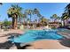 Community pool with palm trees and lounge chairs at 7173 S Durango Dr # 307, Las Vegas, NV 89113
