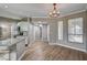 Corner dining area boasts an elegant chandelier, wood flooring, and bright windows at 7173 S Durango Dr # 307, Las Vegas, NV 89113