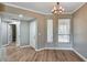 Dining area featuring a modern light fixture, wood floors, and access to other rooms via white doors at 7173 S Durango Dr # 307, Las Vegas, NV 89113