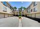 Condos arranged around a well-maintained central courtyard with palm trees and green landscaping at 7173 S Durango Dr # 307, Las Vegas, NV 89113