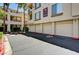 View of condos showing building number, balconies, landscaping, and attached garages at 7173 S Durango Dr # 307, Las Vegas, NV 89113