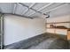 A spacious, empty garage with overhead lighting, empty shelves, and a stained cement floor at 7173 S Durango Dr # 307, Las Vegas, NV 89113