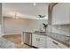 Modern kitchen featuring a peninsula with granite countertop, stainless steel appliances, and open floorplan at 7173 S Durango Dr # 307, Las Vegas, NV 89113
