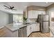 Kitchen with stainless steel appliances, granite countertops, kitchen island, and sliding glass doors to the patio at 7173 S Durango Dr # 307, Las Vegas, NV 89113