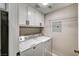 Laundry room with full-size washer and dryer, overhead shelving, and neutral-toned walls at 7173 S Durango Dr # 307, Las Vegas, NV 89113