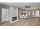 Stylish living room with a fireplace, wood floors, and a kitchen featuring bar stool seating at the counter at 7173 S Durango Dr # 307, Las Vegas, NV 89113