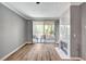 Bright living room featuring wood floors, a fireplace, crown molding, and sliding glass doors to the patio at 7173 S Durango Dr # 307, Las Vegas, NV 89113