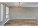 Bright living room featuring wood flooring, a modern chandelier, and large windows with natural light at 7173 S Durango Dr # 307, Las Vegas, NV 89113