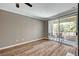 Spacious living room featuring wood floors, crown molding, and a sliding glass door to a patio with furniture at 7173 S Durango Dr # 307, Las Vegas, NV 89113
