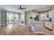 Open living space boasts hard wood flooring, a ceiling fan, fireplace, and a sliding glass door to the patio at 7173 S Durango Dr # 307, Las Vegas, NV 89113
