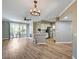 Open living space with wood floors, modern light fixture, kitchen with stainless steel appliances, and access to balcony at 7173 S Durango Dr # 307, Las Vegas, NV 89113