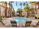 Inviting community pool with lounge chairs and manicured landscaping at 7173 S Durango Dr # 307, Las Vegas, NV 89113