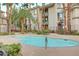 Calm community pool surrounded by manicured landscaping and residential buildings at 7173 S Durango Dr # 307, Las Vegas, NV 89113