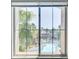 Condo window view overlooking a community pool surrounded by palm trees and landscaping at 7173 S Durango Dr # 307, Las Vegas, NV 89113