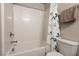 Clean bathroom featuring a shower-tub combination with white tile surround and a decorative shower curtain at 7302 Sunray Point St, North Las Vegas, NV 89084