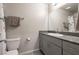 Modern bathroom vanity with granite countertop and shower at 7302 Sunray Point St, North Las Vegas, NV 89084