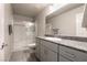 Bathroom featuring a glass-enclosed shower and granite countertops with stylish cabinetry at 7302 Sunray Point St, North Las Vegas, NV 89084