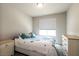 Bedroom with a large window and neutral wall paint at 7302 Sunray Point St, North Las Vegas, NV 89084