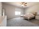 Bedroom with large window, ceiling fan, and soft neutral color scheme at 7302 Sunray Point St, North Las Vegas, NV 89084