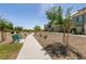 Landscaped community pathway with lush trees and seating areas for residents to enjoy the outdoors at 7302 Sunray Point St, North Las Vegas, NV 89084