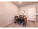Cozy dining area featuring a wood table with black chairs and a decorative mirror on the wall at 7302 Sunray Point St, North Las Vegas, NV 89084
