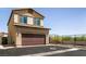 Two story home with a large garage and a paved driveway, complemented by desert landscaping at 7302 Sunray Point St, North Las Vegas, NV 89084