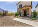 Two-story home featuring a gated front yard and a covered entryway with brick-paved accents at 7302 Sunray Point St, North Las Vegas, NV 89084