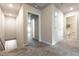 Bright hallway with neutral carpet leads to various rooms, showcasing the home's layout at 7302 Sunray Point St, North Las Vegas, NV 89084