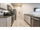 Well-equipped kitchen featuring stainless steel appliances, granite countertops, and ample cabinet space at 7302 Sunray Point St, North Las Vegas, NV 89084