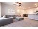 Open-concept living room with carpet, neutral tones, and a dining area adjacent to the kitchen at 7302 Sunray Point St, North Las Vegas, NV 89084
