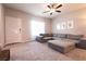 Spacious living room featuring neutral walls, plush carpet, and a large sectional sofa at 7302 Sunray Point St, North Las Vegas, NV 89084